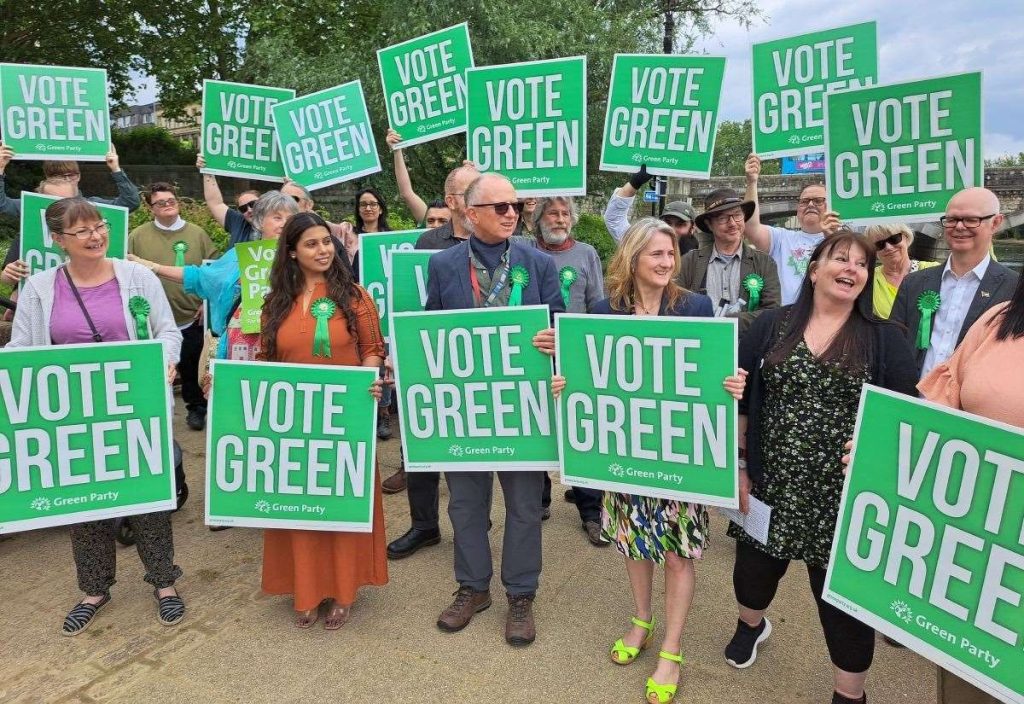 Photo of people holding Vote Green placards. Source: Kent Greens Facebook page